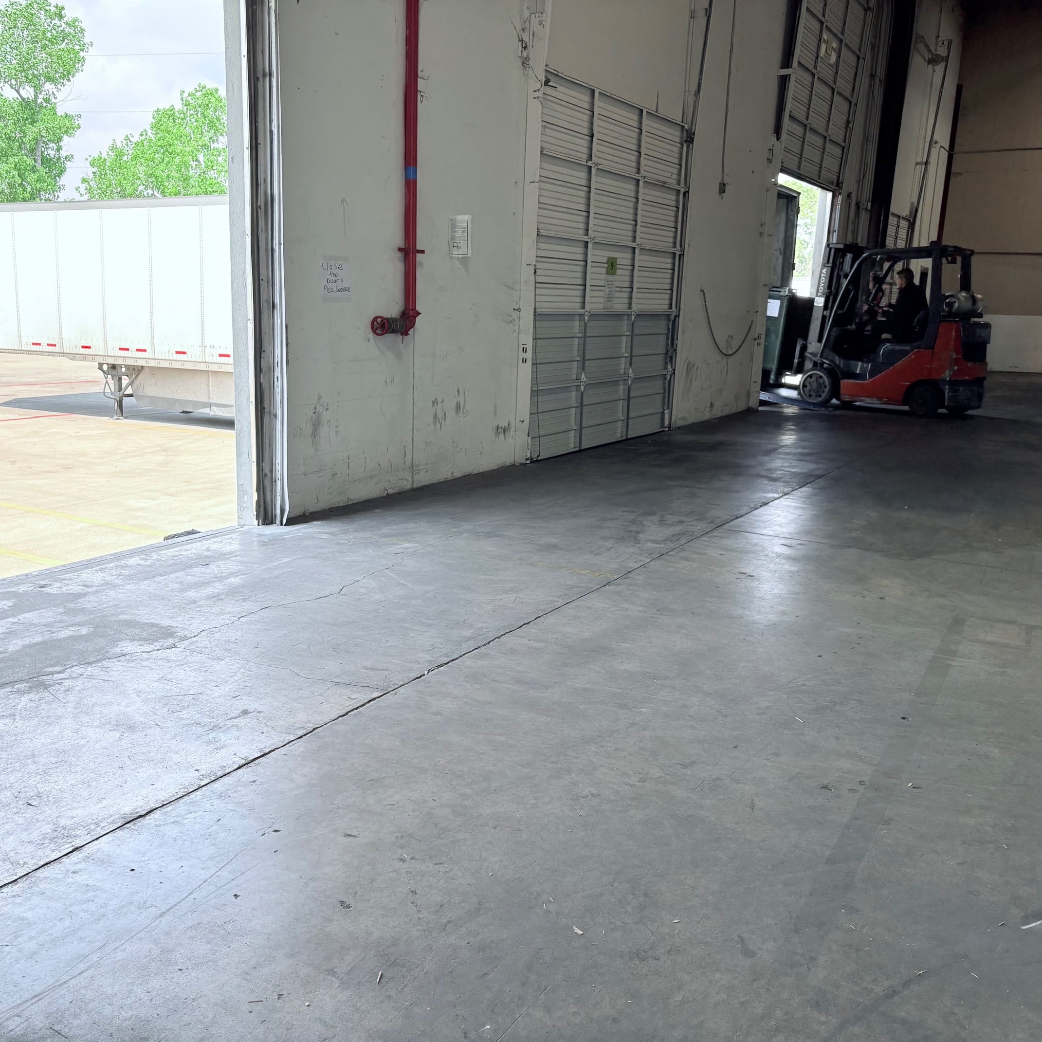 “Team member loading textbooks into truck for shipping.”